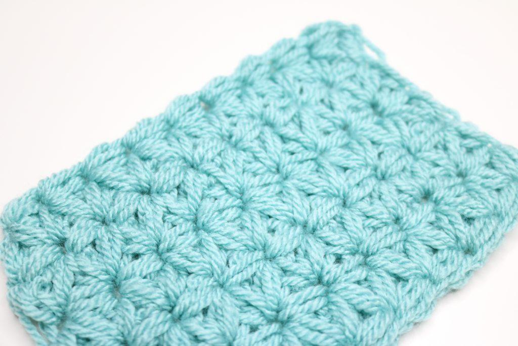 A blue swatch of the Jasmine stitch on a white background.
