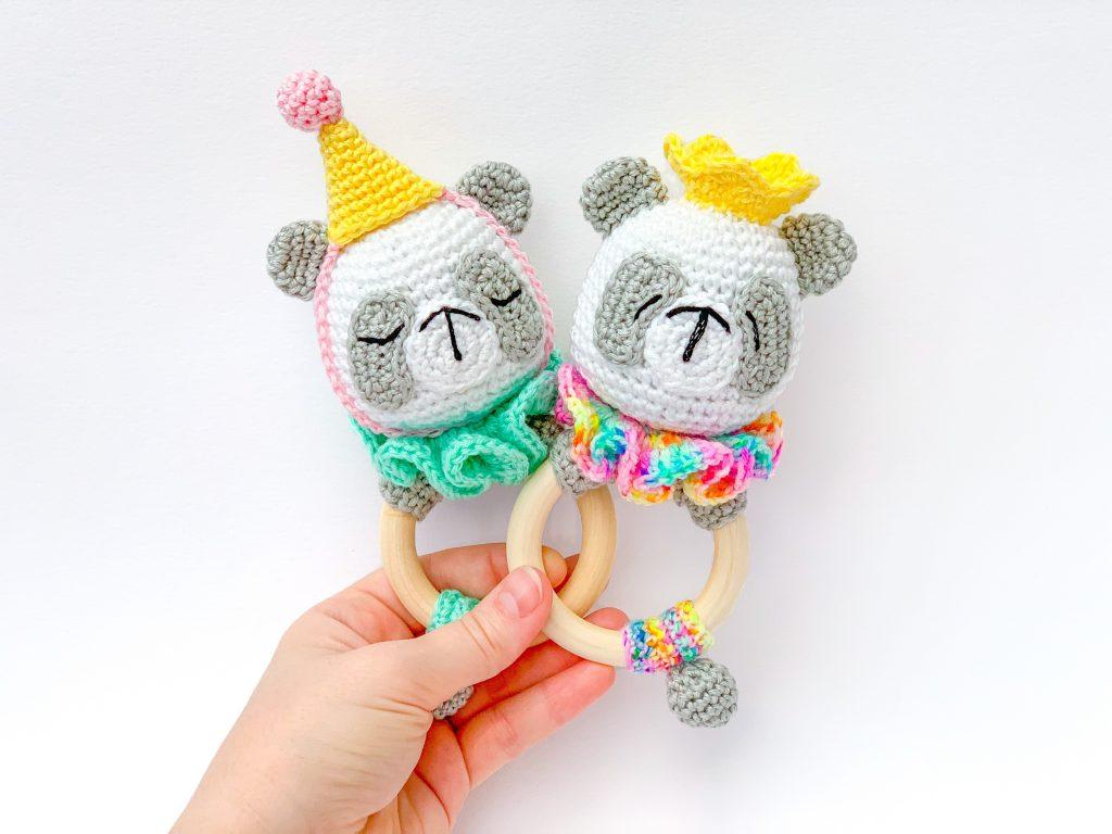 A pair of panda motif rings are crocheted in bright colourful yarn.