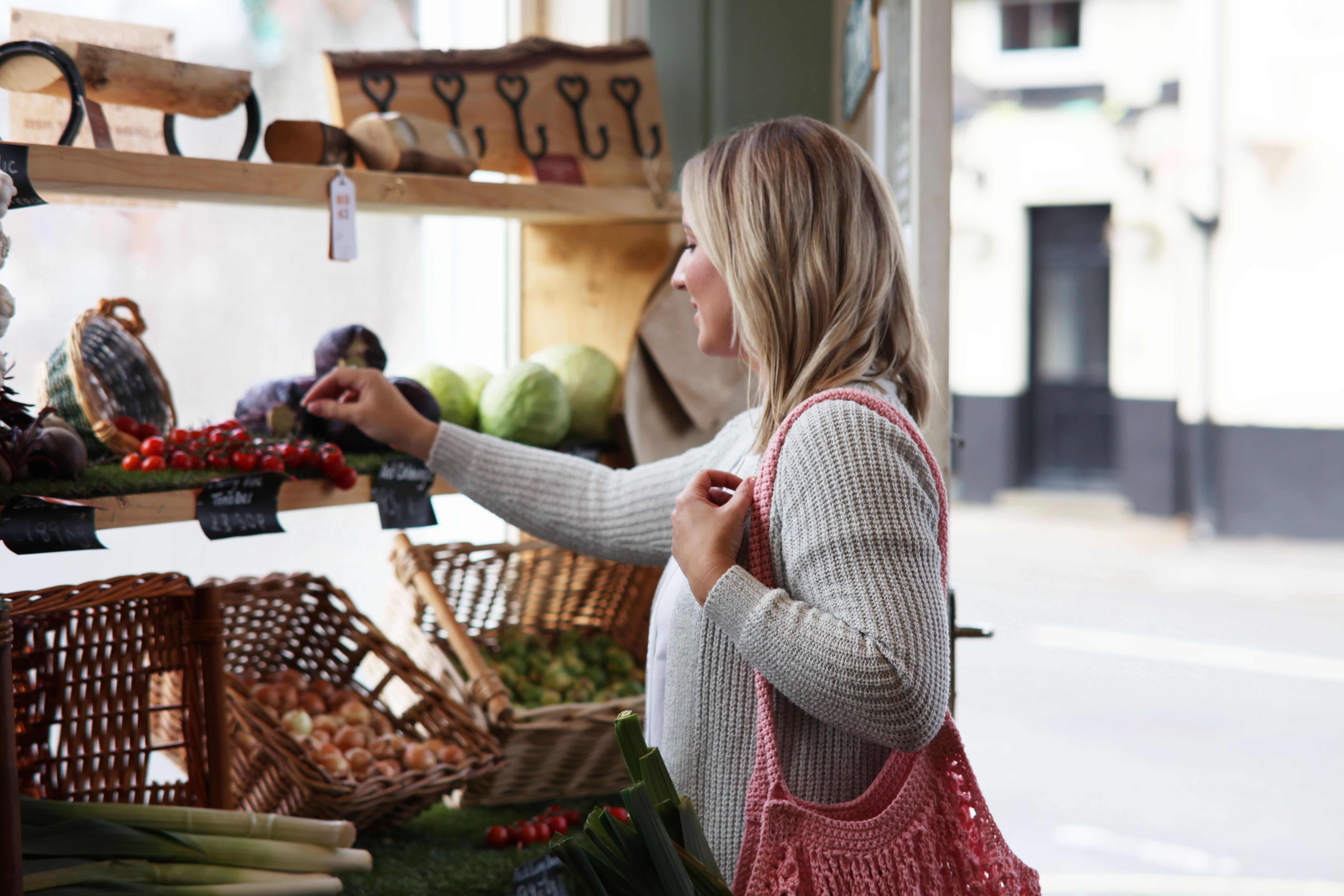 Lady out at a market with a crochet bag
