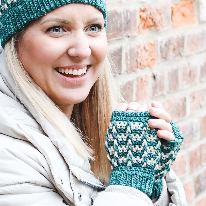 female stood outside wearing a crochet beanie hat in red and cream indie-dyed yarn.