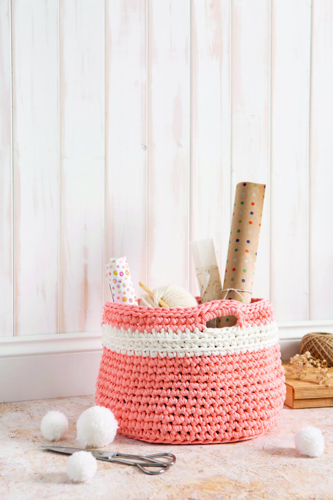 basket filled with gift wrap and yarn made of crochet t shirt yarn