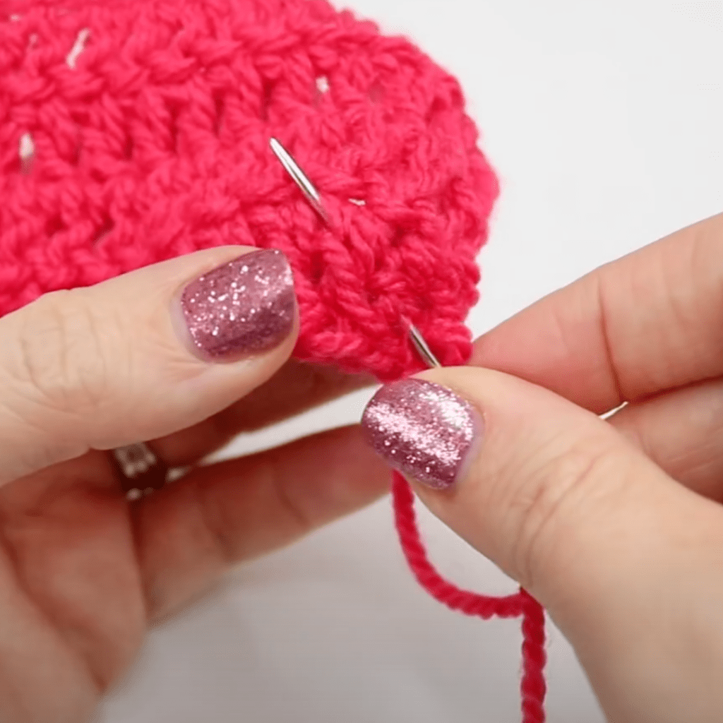 Sewing in the ends of a crochet project.