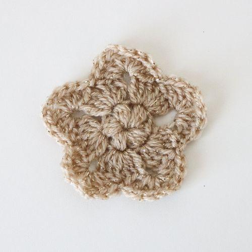 a flat lay image of a crochet star made using a sparkly DK yarn to show how it looks using this yarn and a 4mm hook.