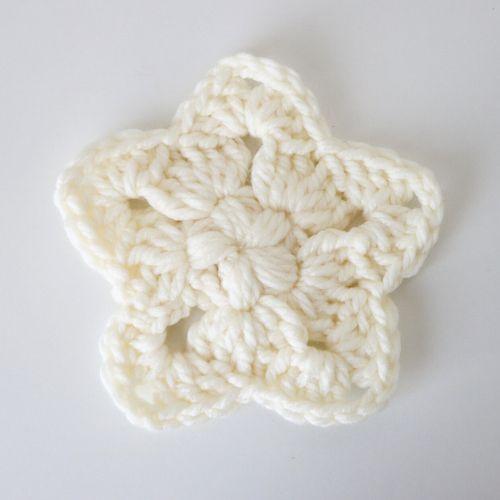 a flat lay image of a crochet star made in a chunky cream yarn and a 9mm hook to show you what it looks like.