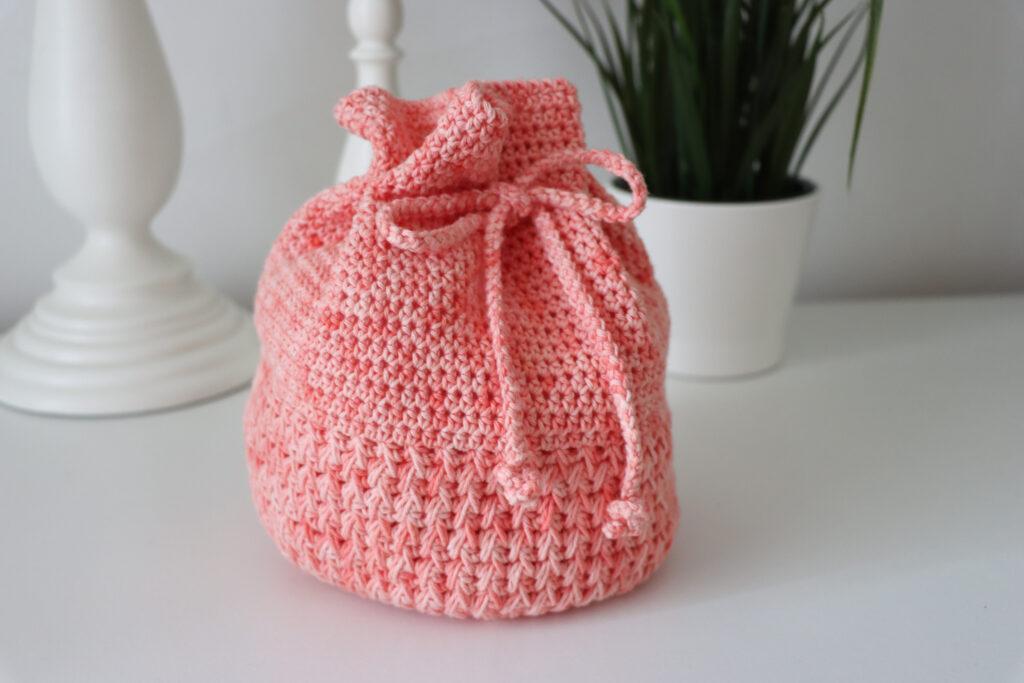 Crochet drawstring bag close up, made with Peach Ice coloured yarn.
